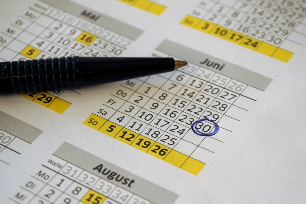 Pen resting on a printed calendar